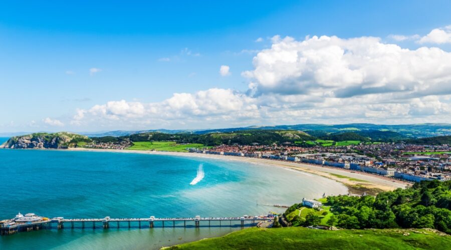 Beautiful Summer Day looking over the pier in Llandudno Sea Front in North Wales, United Kingdom