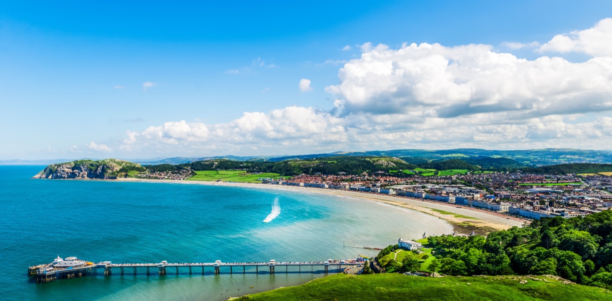 Beautiful Summer Day looking over the pier in Llandudno Sea Front in North Wales, United Kingdom