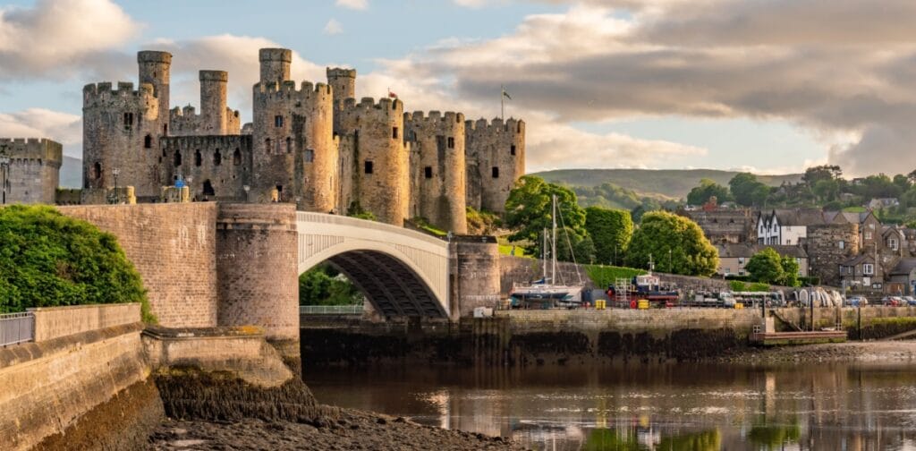 Sunset over the Conwy Estuary and Castle with Snowdonia mountains in the background
