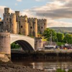 Sunset over the Conwy Estuary and Castle with Snowdonia mountains in the background