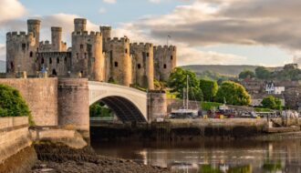 Sunset over the Conwy Estuary and Castle with Snowdonia mountains in the background