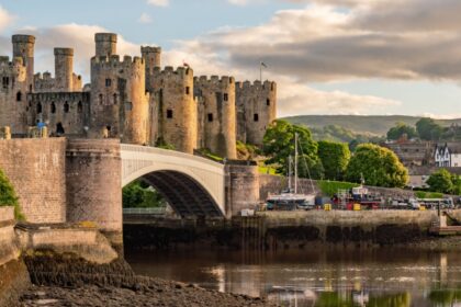 Sunset over the Conwy Estuary and Castle with Snowdonia mountains in the background