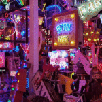 A colourful jumble of neon signs at God’s Own Junkyard in Walthamstow, London, featuring glowing slogans, vintage advertisements, and salvaged lights packed into a vibrant indoor display.