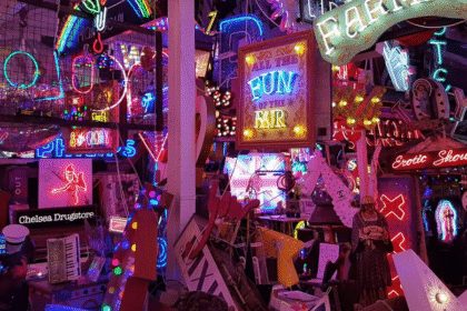 A colourful jumble of neon signs at God’s Own Junkyard in Walthamstow, London, featuring glowing slogans, vintage advertisements, and salvaged lights packed into a vibrant indoor display.