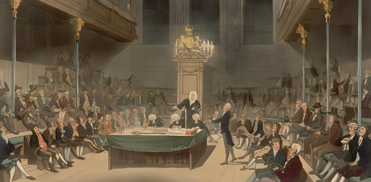 Historic painting of the House of Commons in the late 18th century, showing a crowded parliamentary session with men in period dress seated on benches and gathered around a central table. A speaker stands addressing the chamber while others listen attentively. The scene captures the era of William Wilberforce and the abolition debates, with candlelight illuminating the ornate wooden interior and royal crest above the speaker's chair.
