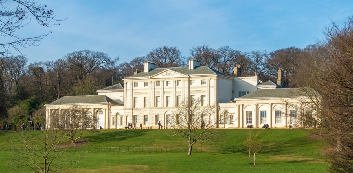 Kenwood House, a grand 18th-century stately home with white neoclassical façade, set in green parkland on Hampstead Heath in London
